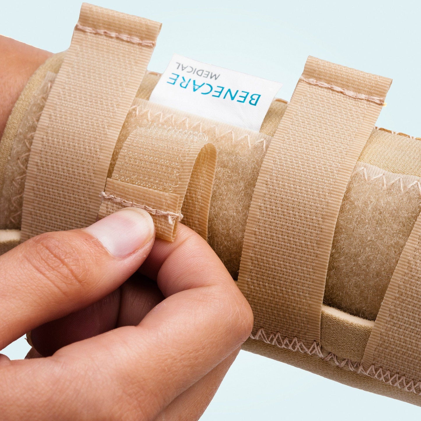 The Benecare Neoprene Open Wrist/Thumb Support hook and loop straps.