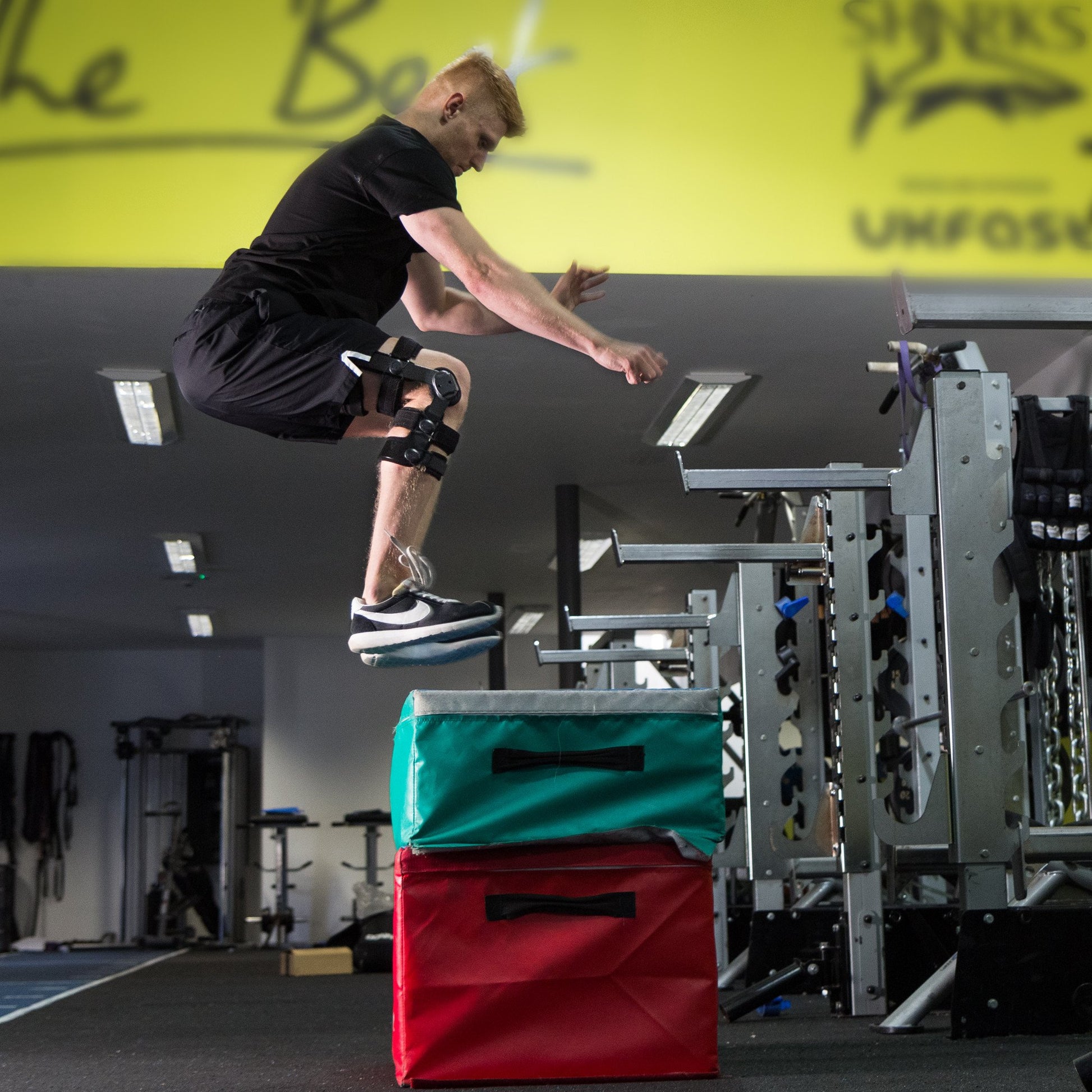 Athlete doing box jump wearing the Benecare Pro Action Knee Brace.